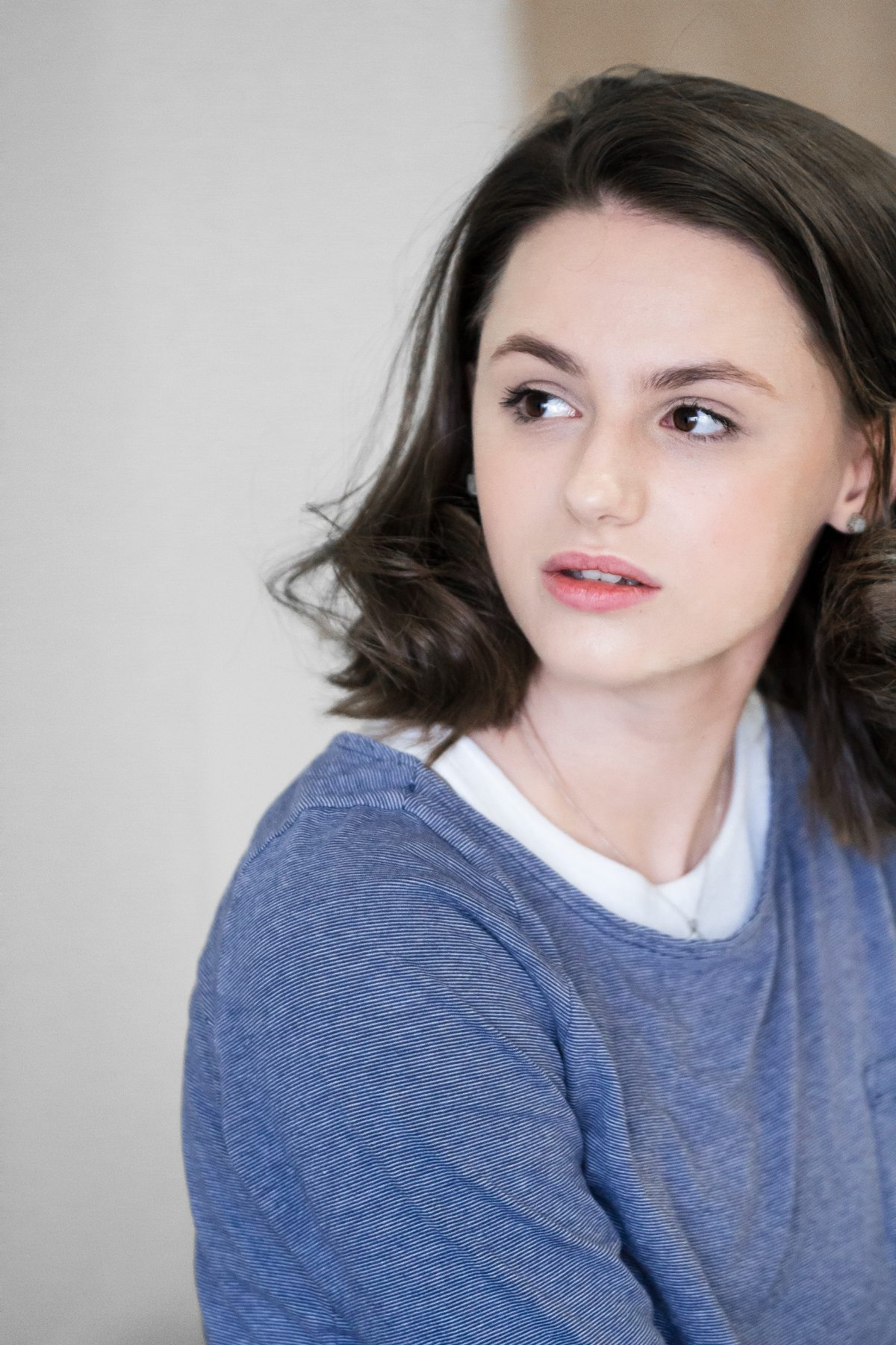 An actor glancing over her shoulder, listening