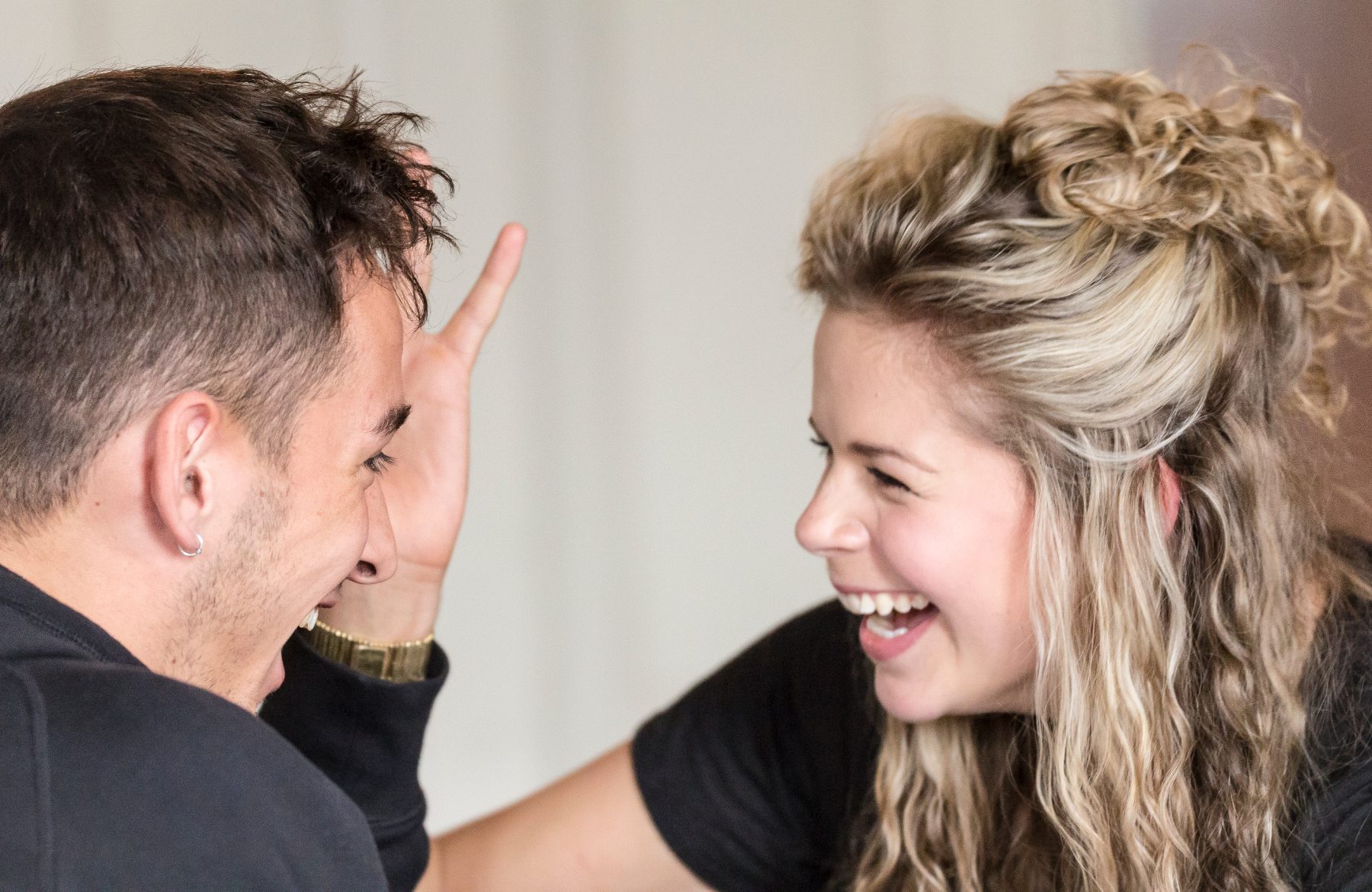 Two actors laughing together mid-exercise
