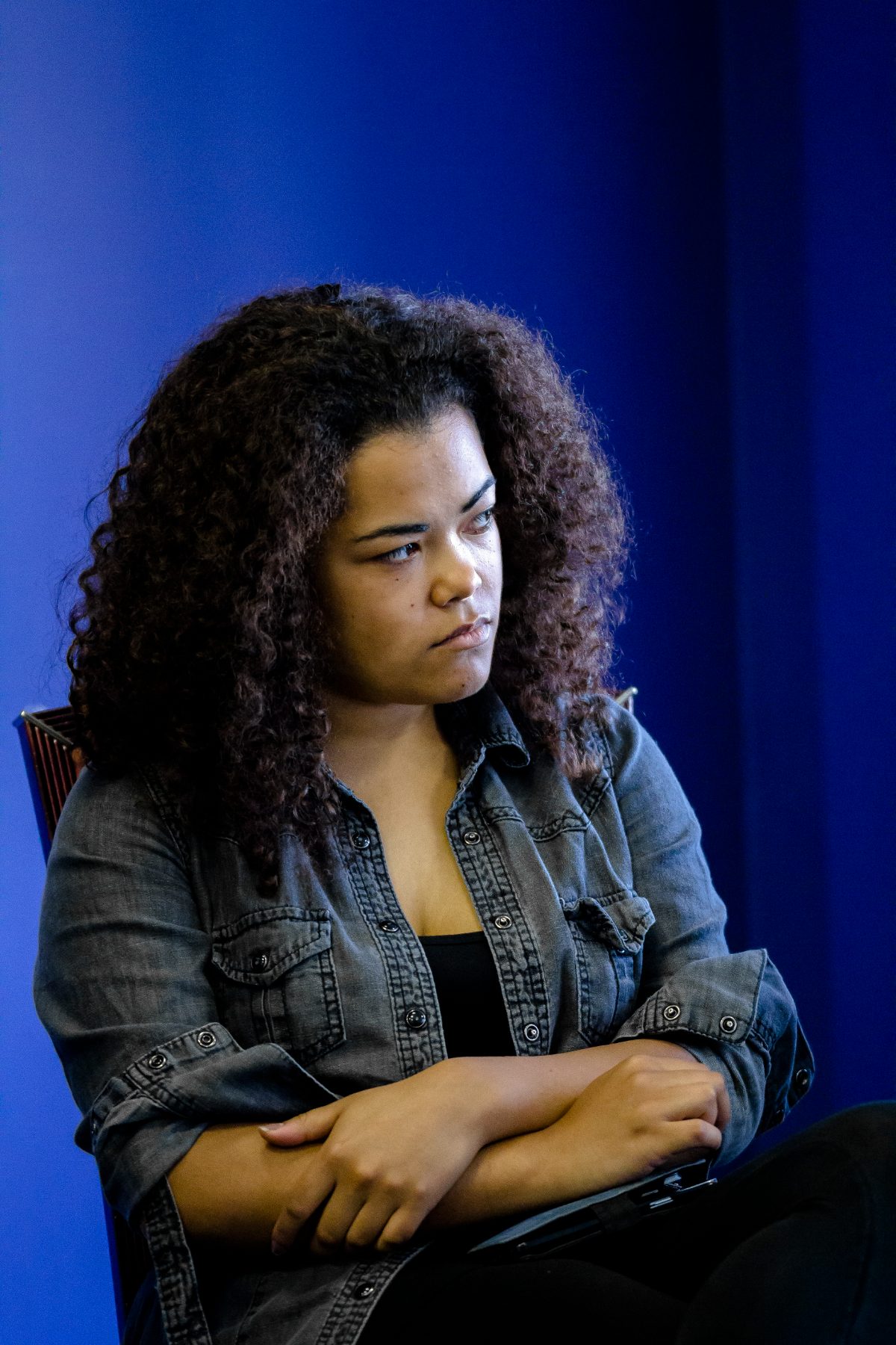 An actor watching a scene, arms folded